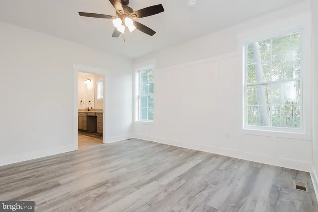 a bathroom with a granite countertop sink and a window