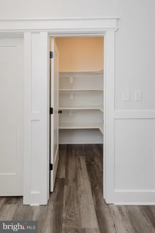 a view of an empty room and wooden floor