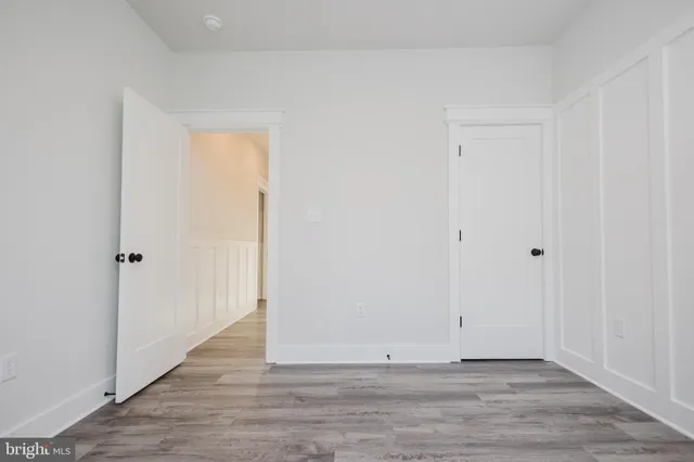a view of a room with wooden floor and window
