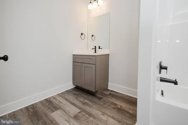 a view of a house with a yard and pathway