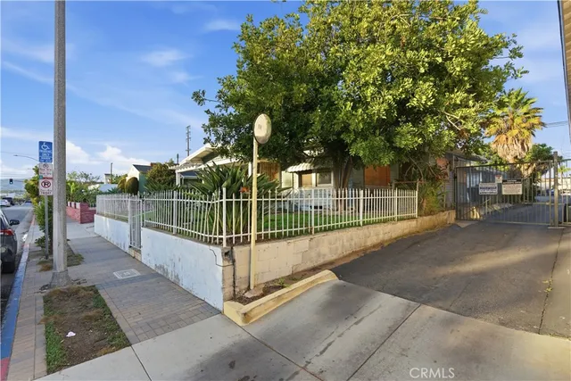 a view of a park with iron fence