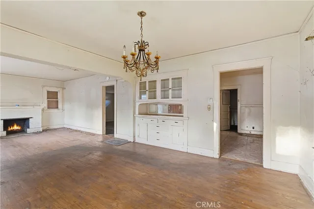 a view of a livingroom with a chandelier fan and windows