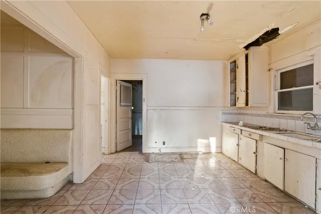 a bathroom with a granite countertop sink and a toilet