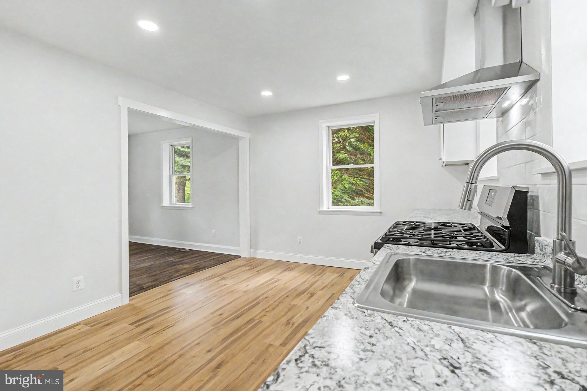 604 Prospect Mill Road Bel Air, MD 21015 - Photo 15 of 36 a kitchen with a sink wooden floor and a window