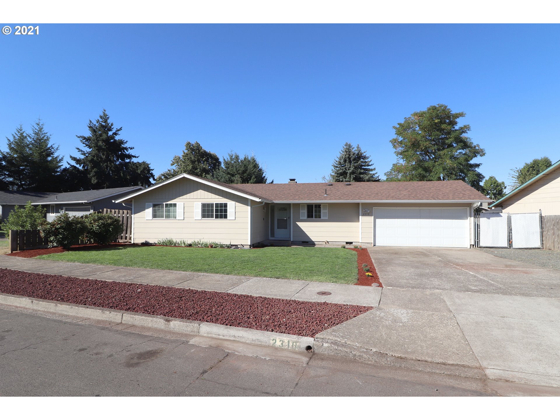 2310 6th Street Springfield, OR 97477 - Photo 1 of 32 a front view of a house with a yard and garage