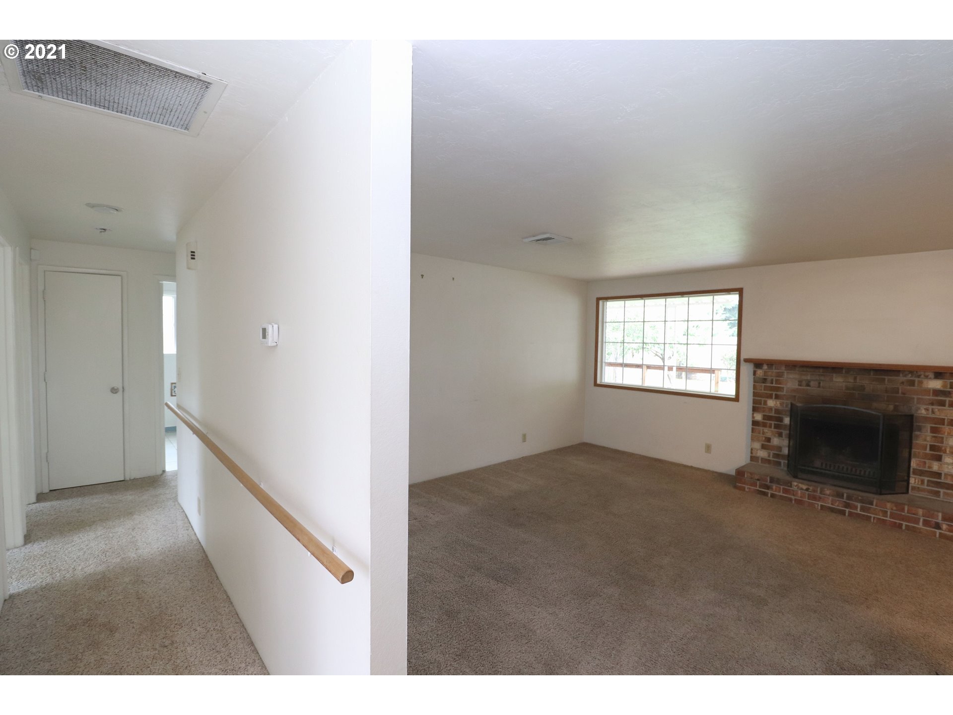 2310 6th Street Springfield, OR 97477 - Photo 11 of 32 a view of an empty room with a window and fireplace