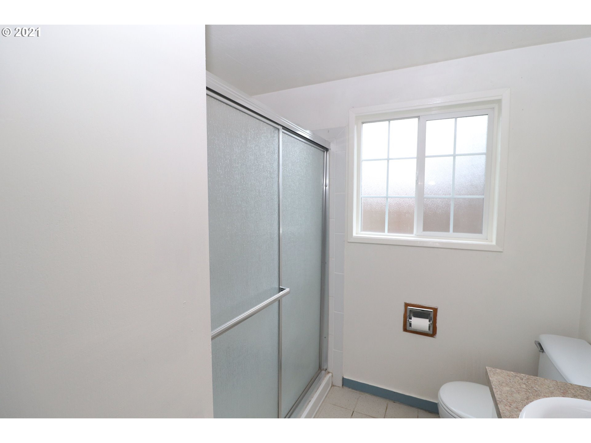 2310 6th Street Springfield, OR 97477 - Photo 15 of 32 a bathroom with a toilet and a window