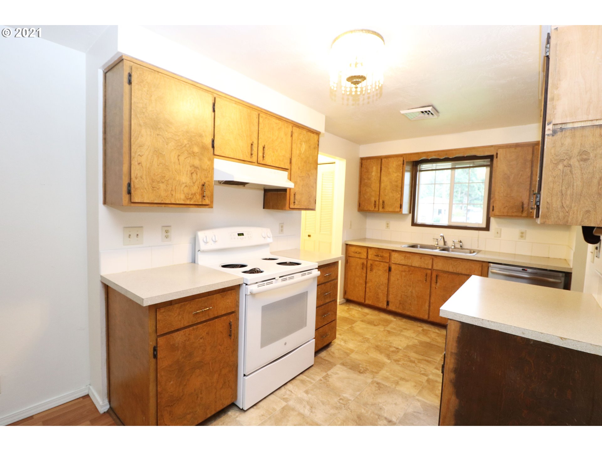 2310 6th Street Springfield, OR 97477 - Photo 7 of 32 a kitchen with stainless steel appliances granite countertop a sink stove and refrigerator