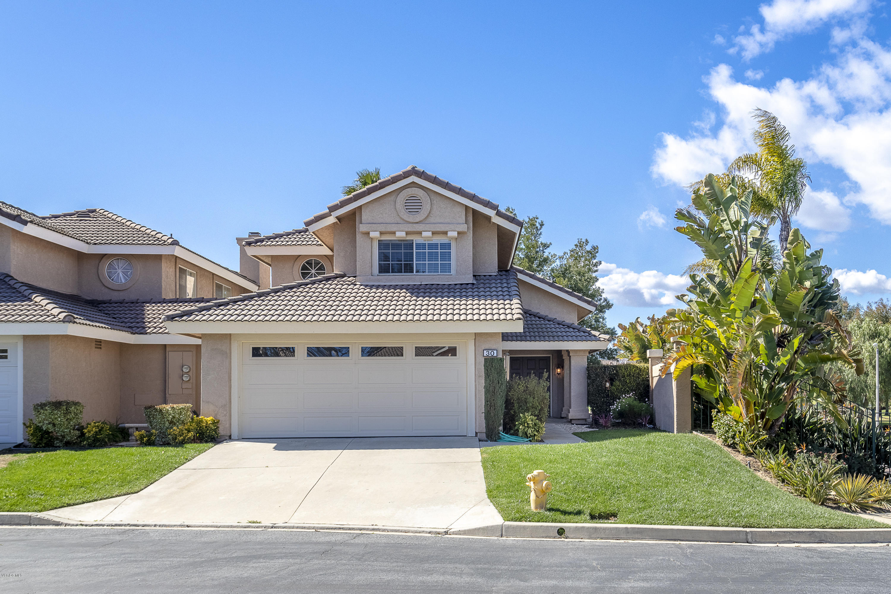 30 Iron Ridge Lane Simi Valley, CA 93065 - Photo 1 of 31 a front view of a house with a yard and garage