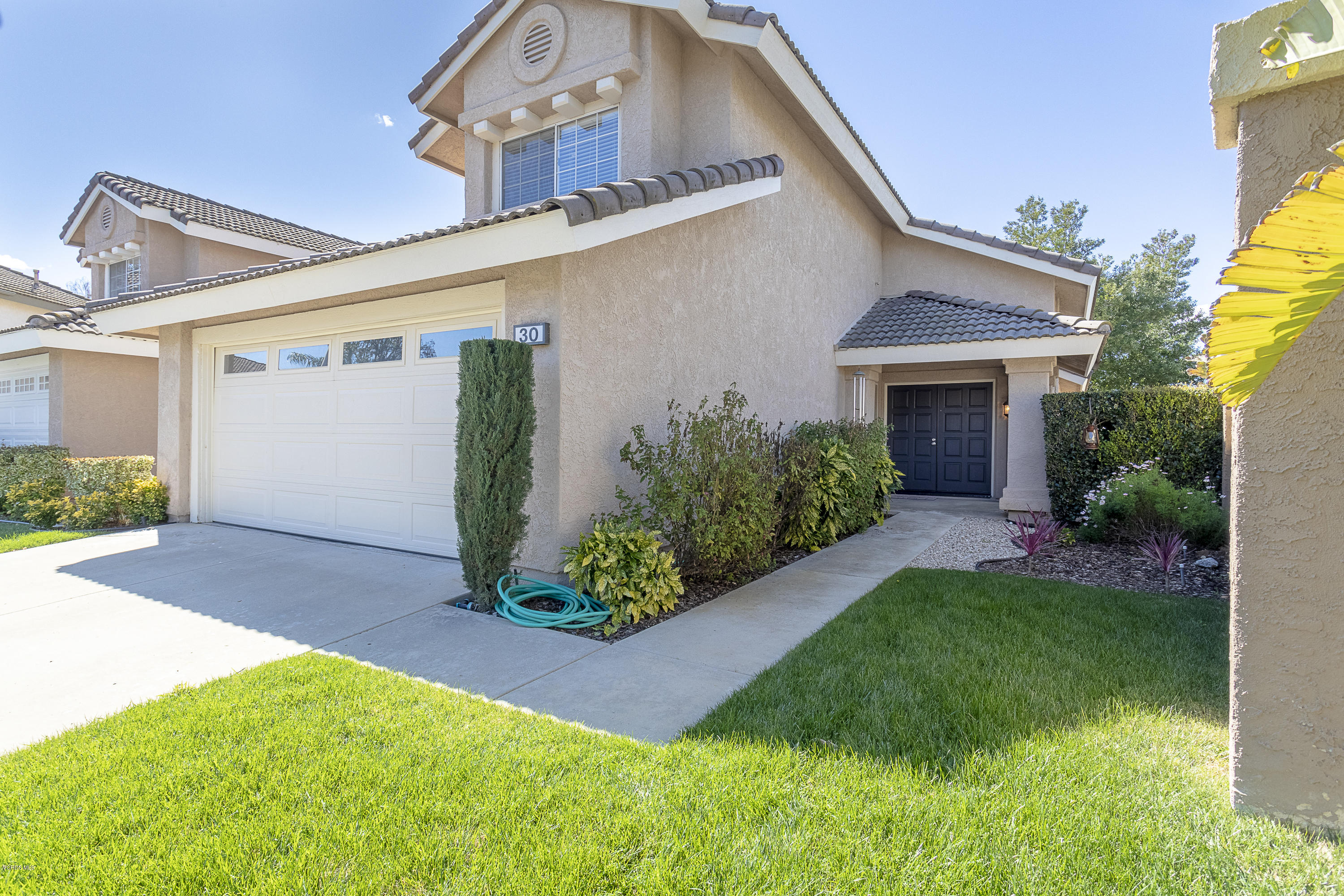 30 Iron Ridge Lane Simi Valley, CA 93065 - Photo 2 of 31 a front view of a house with garden