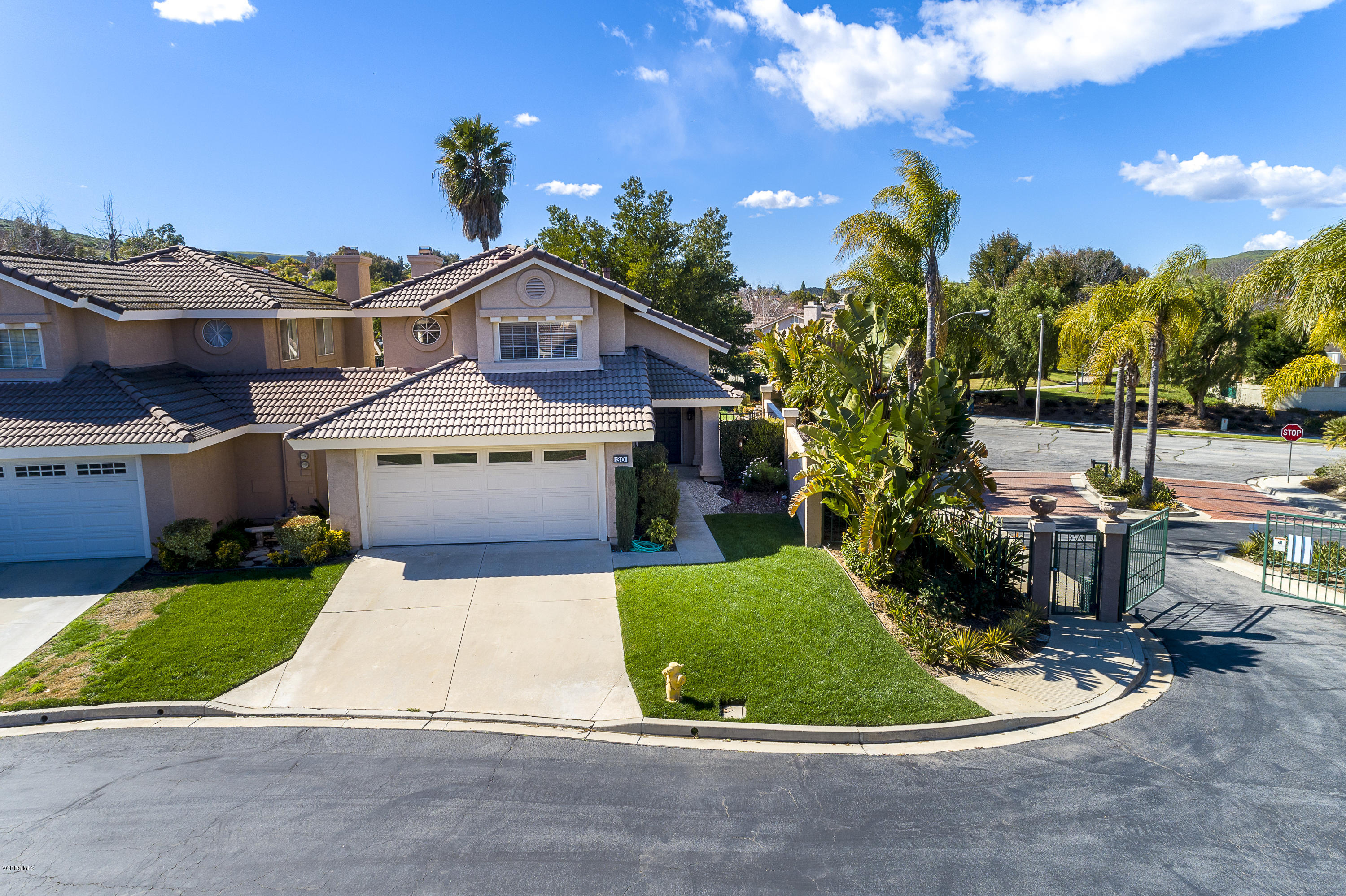 30 Iron Ridge Lane Simi Valley, CA 93065 - Photo 23 of 31 a front view of a house with a yard and garage
