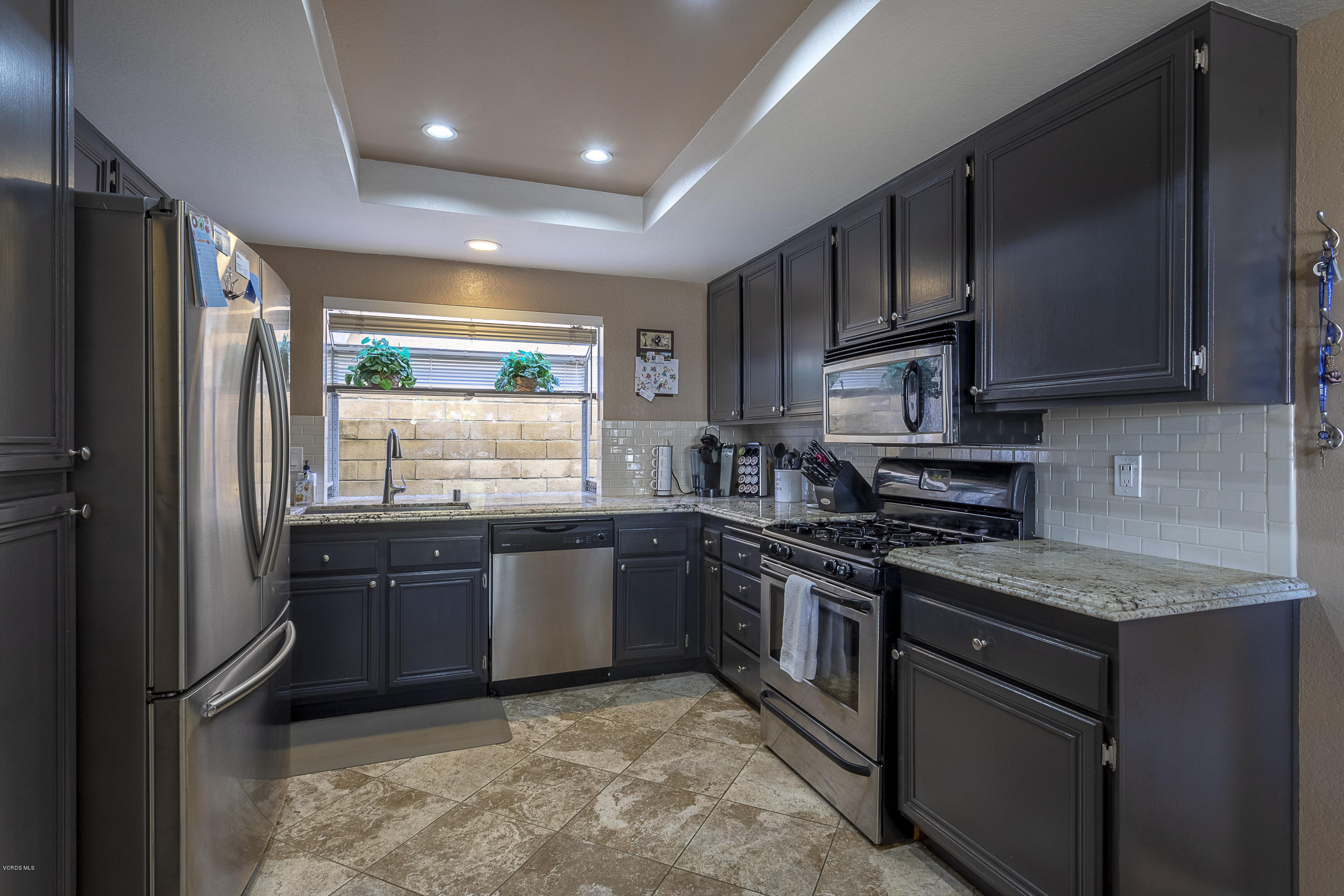 30 Iron Ridge Lane Simi Valley, CA 93065 - Photo 8 of 31 a kitchen with stainless steel appliances granite countertop a stove a refrigerator and a sink