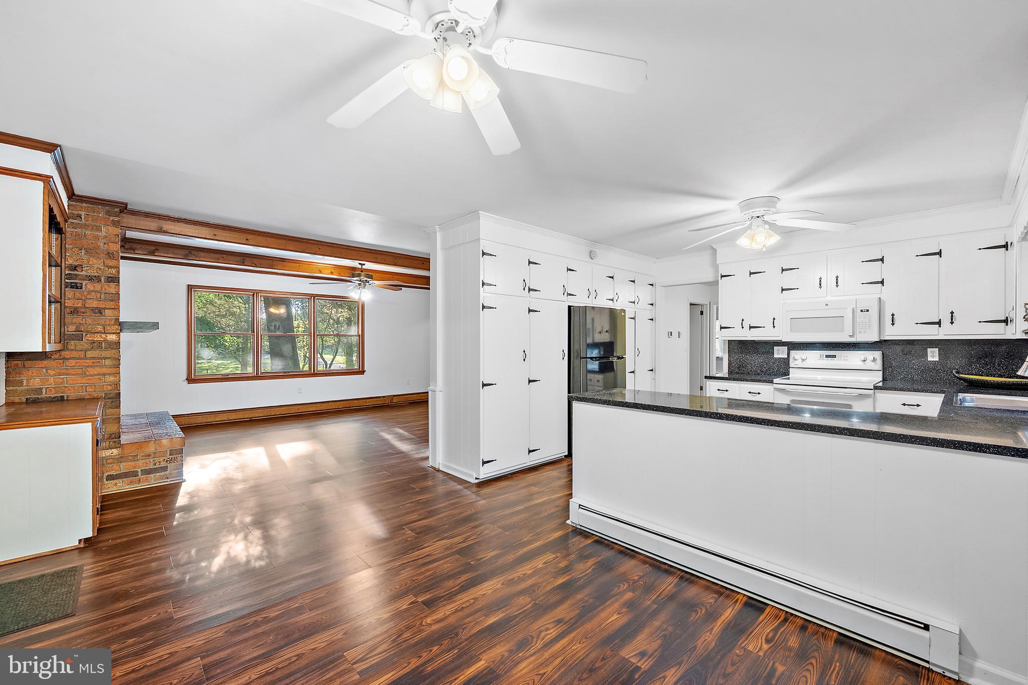6181 Rockawalkin Road Salisbury, MD 21801 - Photo 15 of 65 a kitchen with stainless steel appliances a stove top oven a sink a window and cabinets