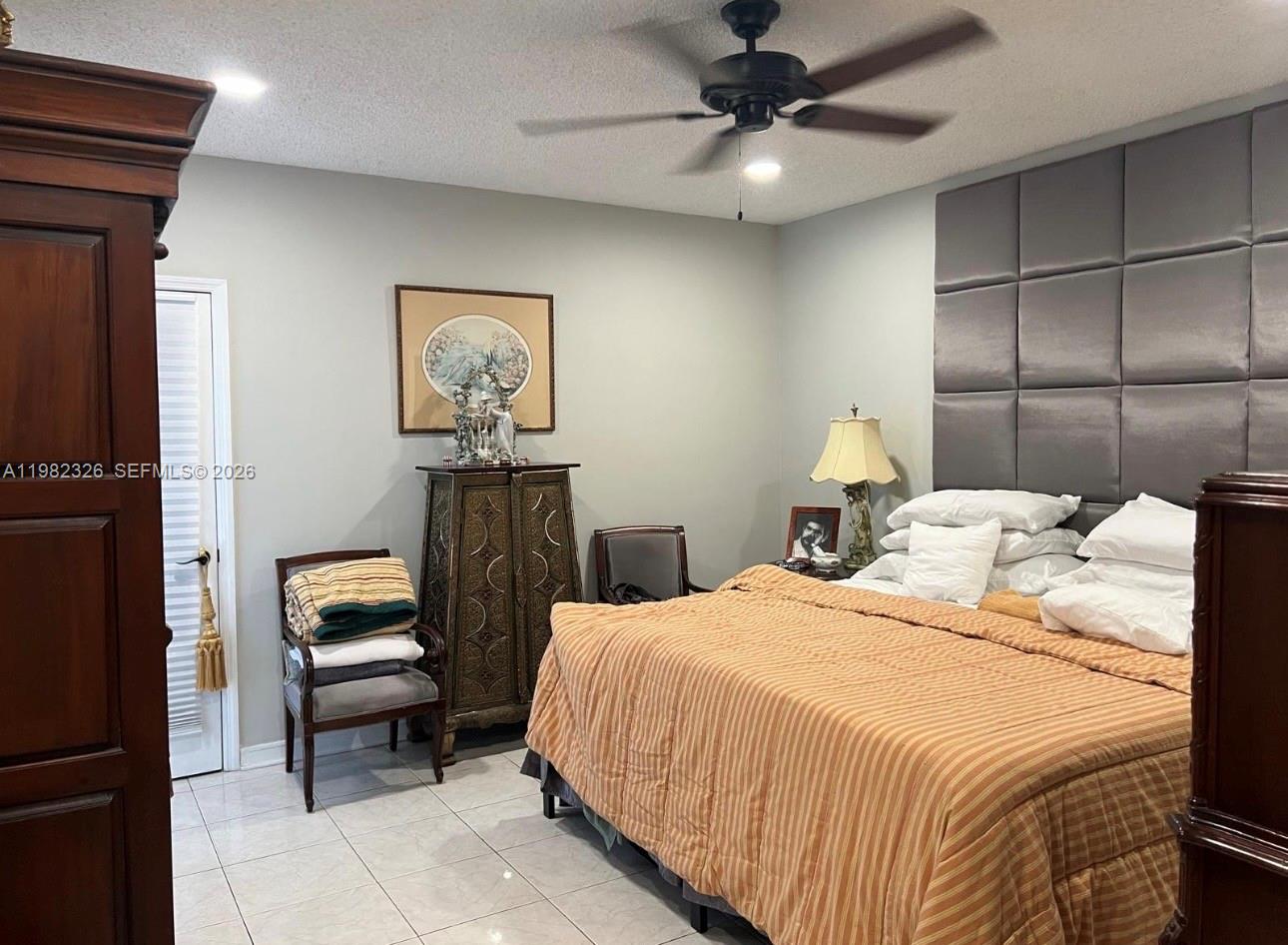 2190 Southwest 22nd Terrace Miami, FL 33145 - Photo 14 of 37 a bedroom with a bed and a chandelier