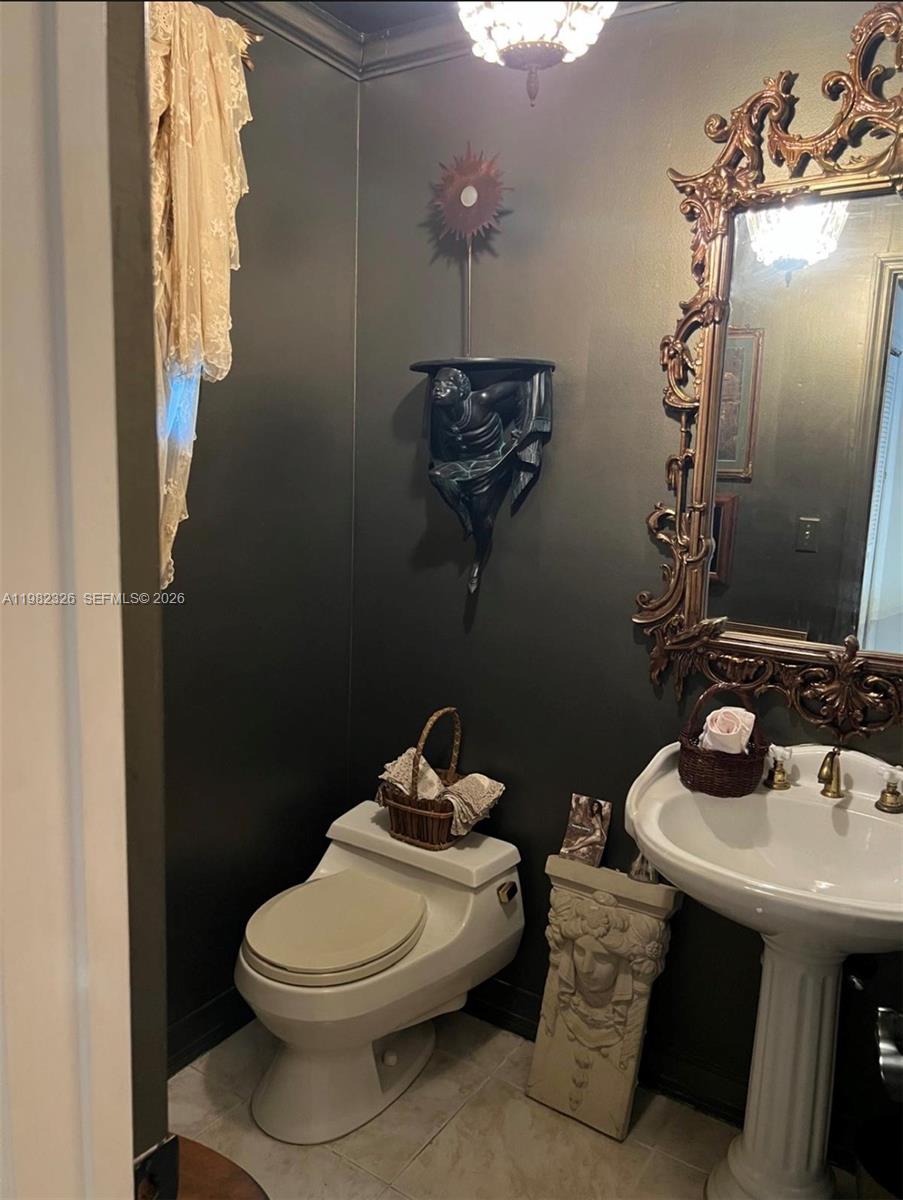 2190 Southwest 22nd Terrace Miami, FL 33145 - Photo 19 of 37 a bathroom with a toilet sink and mirror