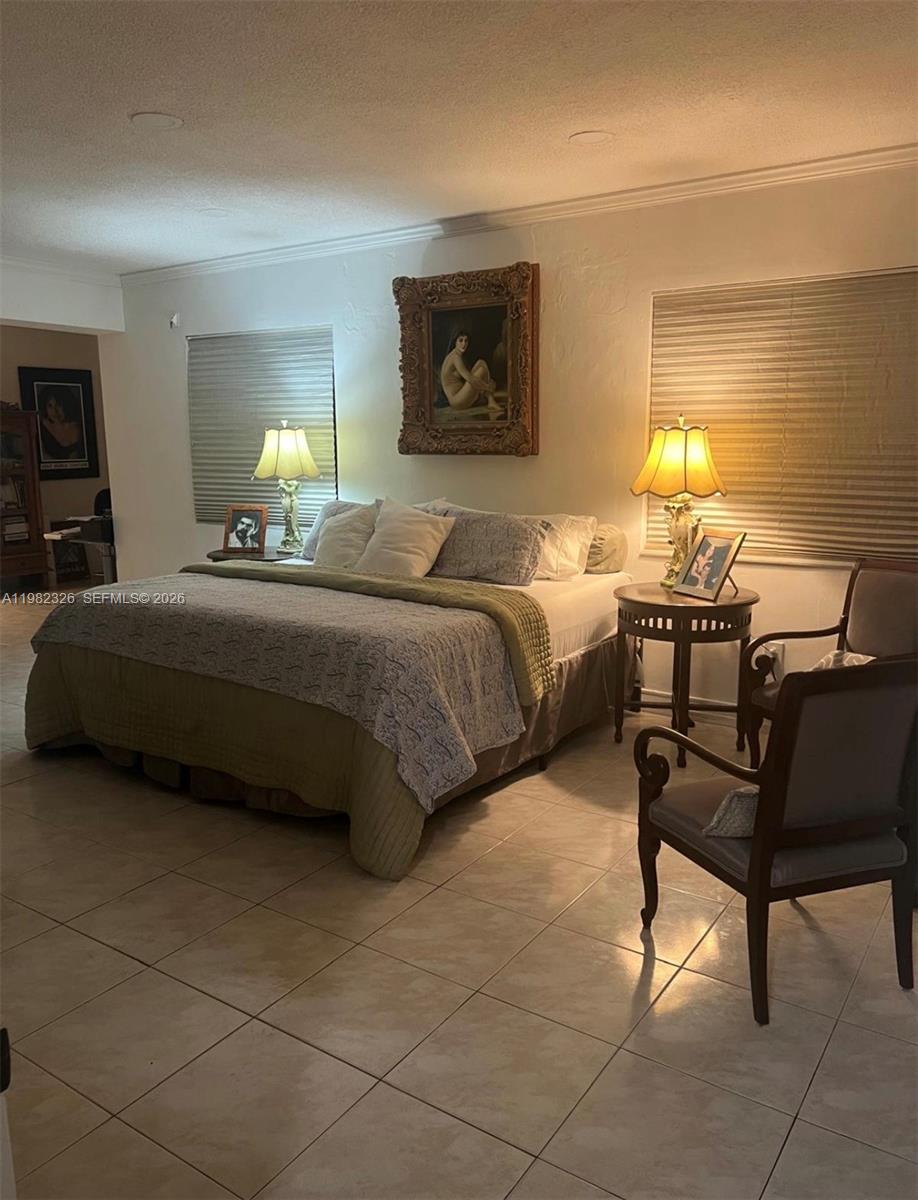 2190 Southwest 22nd Terrace Miami, FL 33145 - Photo 30 of 37 a bedroom with a bed and chair