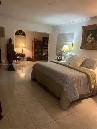 a living room with furniture and a lamp