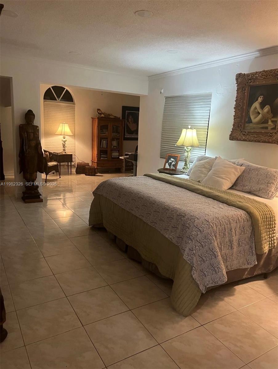 2190 Southwest 22nd Terrace Miami, FL 33145 - Photo 31 of 37 a bedroom with a bed and lamp on dresser