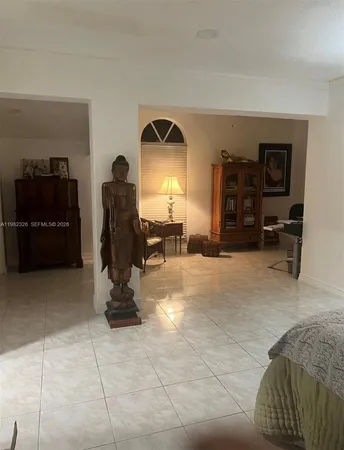 a living room with furniture a piano and a flat screen tv