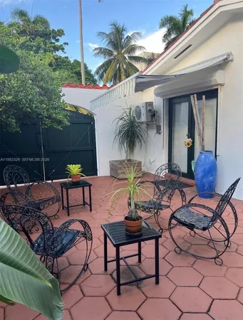 a view of a backyard with swimming pool and furniture