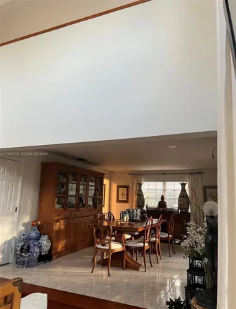 a living room with furniture and a mirror