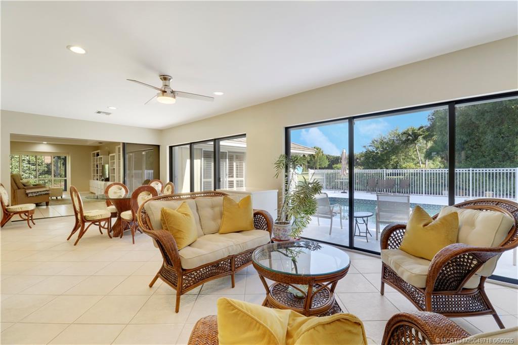 5701 Southeast Winged Foot Drive Stuart, FL 34997 - Photo 1 of 47 a living room with furniture and a large window