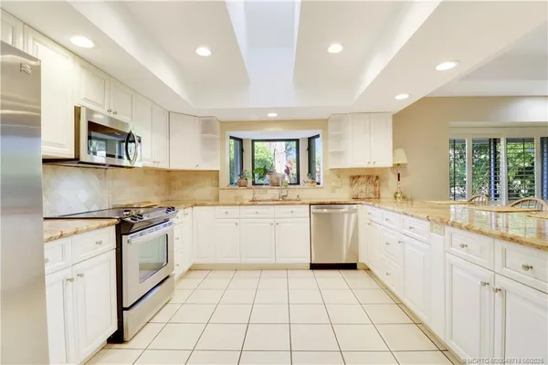 a kitchen with a stove sink and cabinets