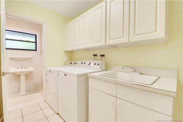 a utility room with a sink washer and dryer