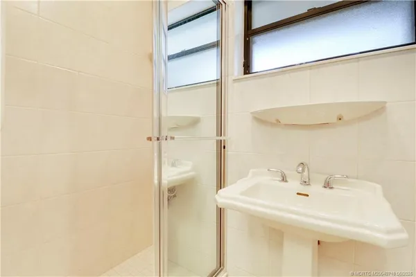 a bathroom with a sink and shower