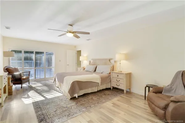 a spacious bedroom with a bed and furniture