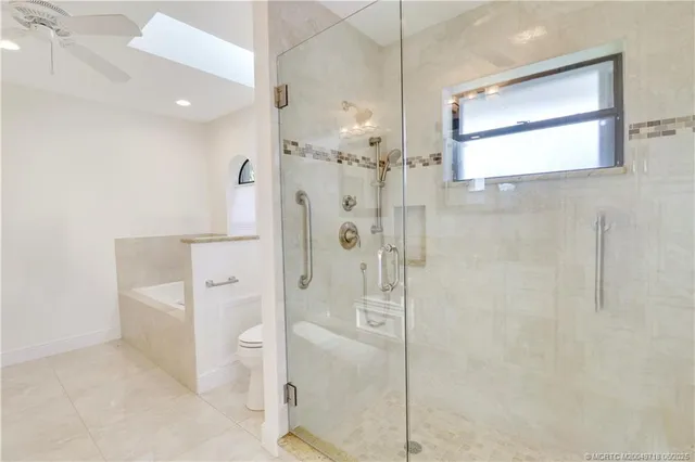 a spacious bathroom with a shower sink and mirror