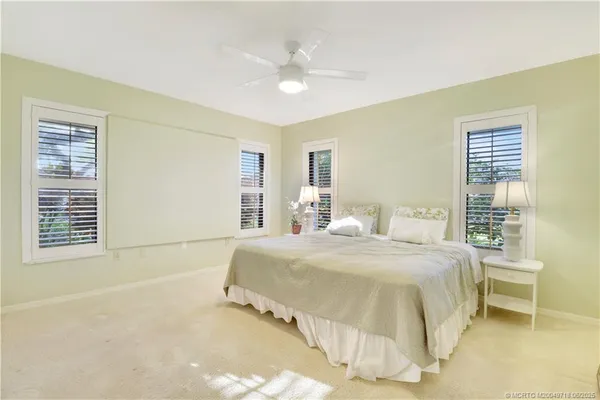 a spacious bedroom with a bed and a table in it