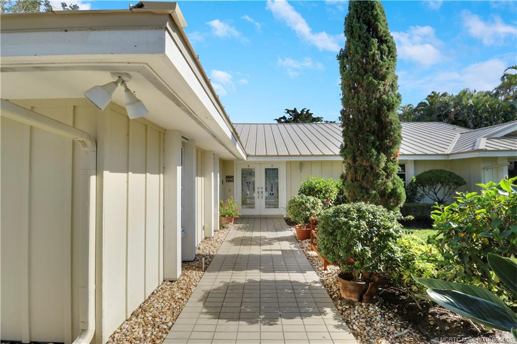 5701 Southeast Winged Foot Drive Stuart, FL 34997 - Photo 3 of 47 a entryway view with a garden