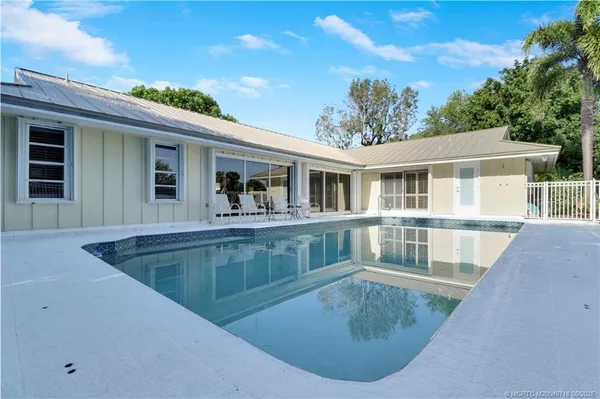 a view of a house with pool and trees
