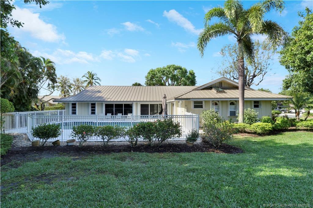 5701 Southeast Winged Foot Drive Stuart, FL 34997 - Photo 34 of 47 a front view of a house with a garden