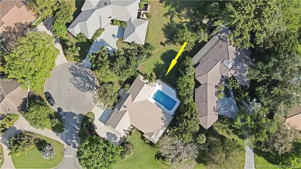 an aerial view of a house with a yard