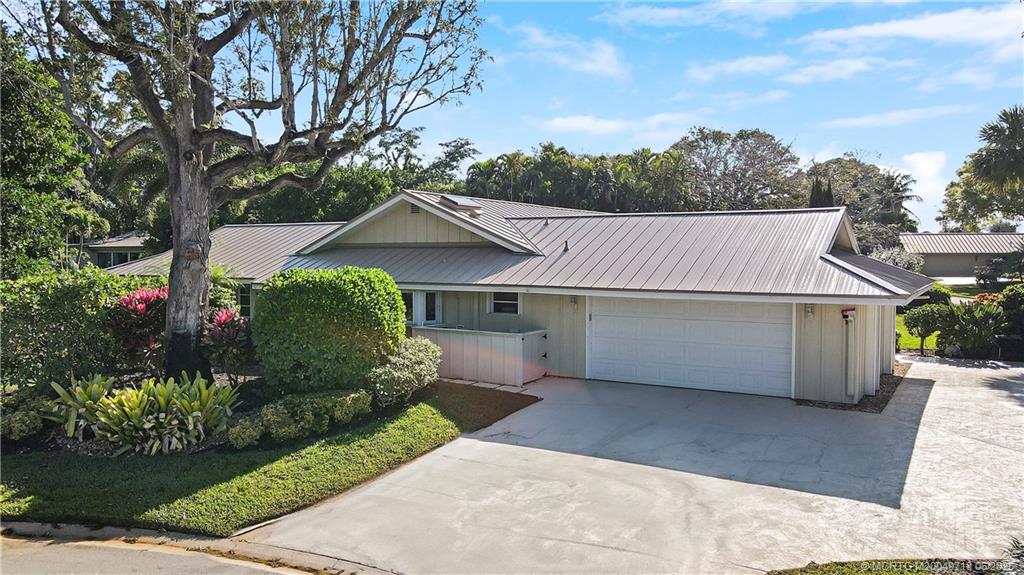 5701 Southeast Winged Foot Drive Stuart, FL 34997 - Photo 47 of 47 a front view of a house with a garden