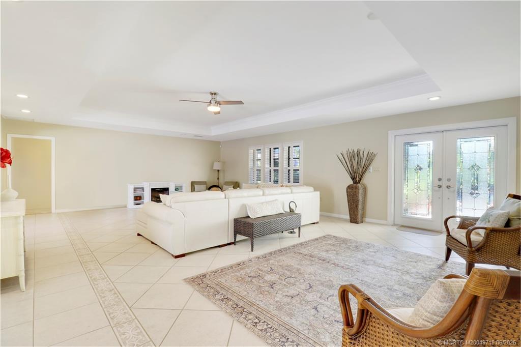 5701 Southeast Winged Foot Drive Stuart, FL 34997 - Photo 7 of 47 a living room with furniture and a large window