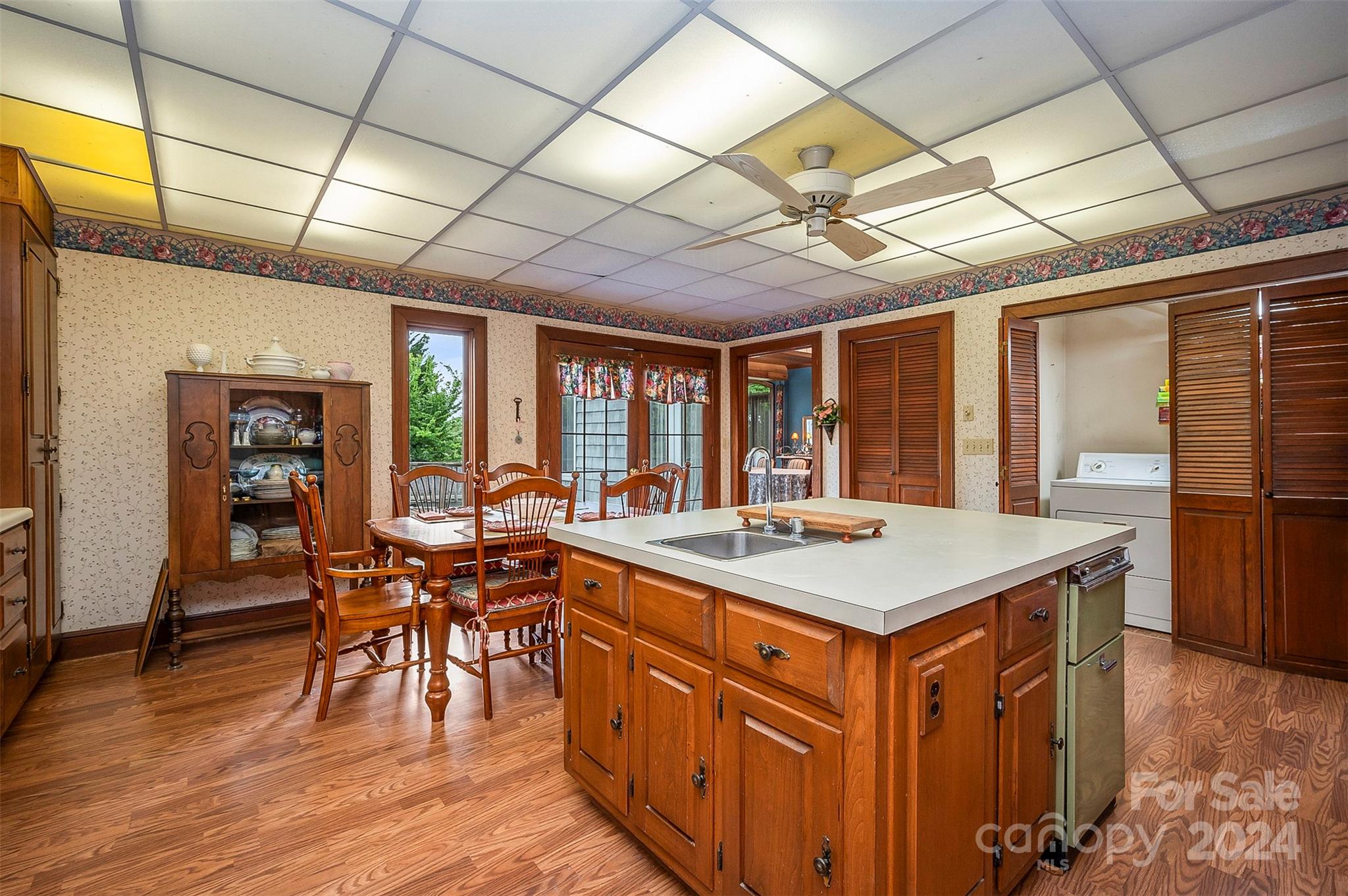 267 South Ridgecrest Avenue Rutherfordton, NC 28139 - Photo 13 of 48 a kitchen with stainless steel appliances granite countertop a stove a refrigerator a dining table and chairs with wooden floor