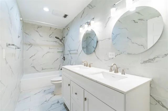 an empty room with a ceiling fan and wooden floor