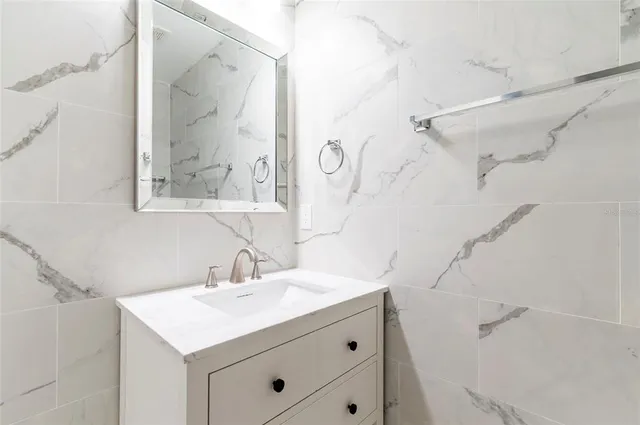 swimming pool view with a seating space