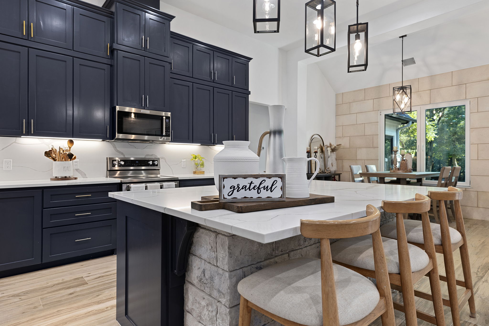 153 Fawn Hollow Elgin, TX 78621 - Photo 11 of 40 a kitchen with a stove a sink and a refrigerator