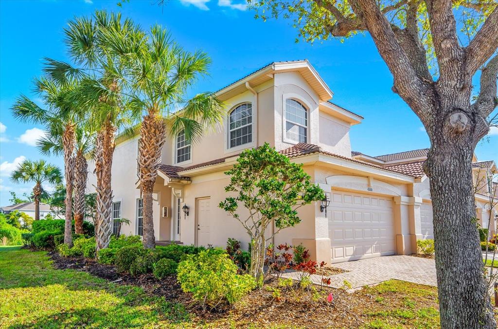 4500 Streamside Court, Unit 1408 Sarasota, FL 34238 - Photo 1 of 73 a front view of a house with a yard