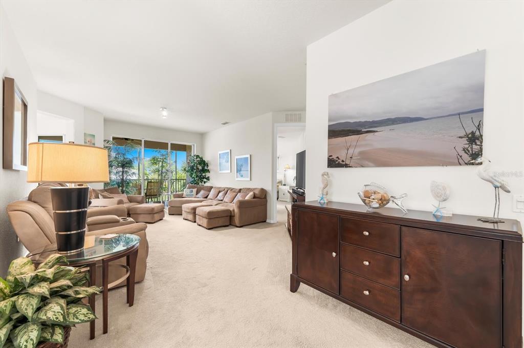 4500 Streamside Court, Unit 1408 Sarasota, FL 34238 - Photo 16 of 73 a living room with furniture and a flat screen tv