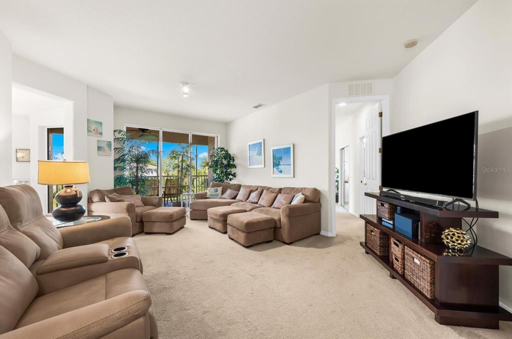 4500 Streamside Court, Unit 1408 Sarasota, FL 34238 - Photo 19 of 73 a living room with furniture and a flat screen tv
