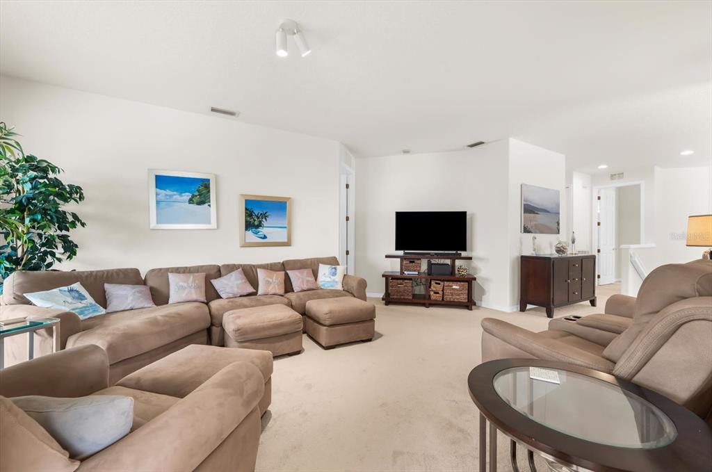 4500 Streamside Court, Unit 1408 Sarasota, FL 34238 - Photo 22 of 73 a living room with furniture a flat screen tv and a fireplace