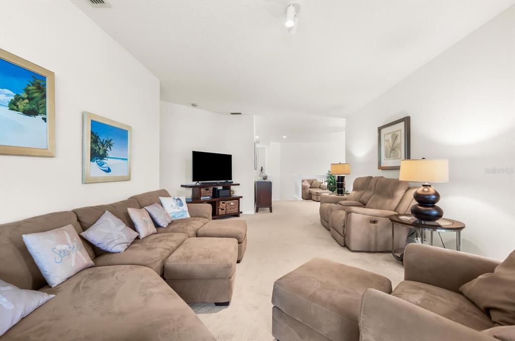4500 Streamside Court, Unit 1408 Sarasota, FL 34238 - Photo 23 of 73 a living room with furniture and a flat screen tv