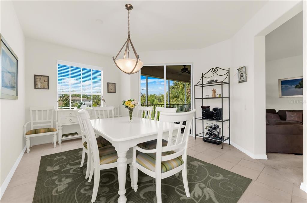 4500 Streamside Court, Unit 1408 Sarasota, FL 34238 - Photo 26 of 73 a view of a dining room with furniture window and wooden floor