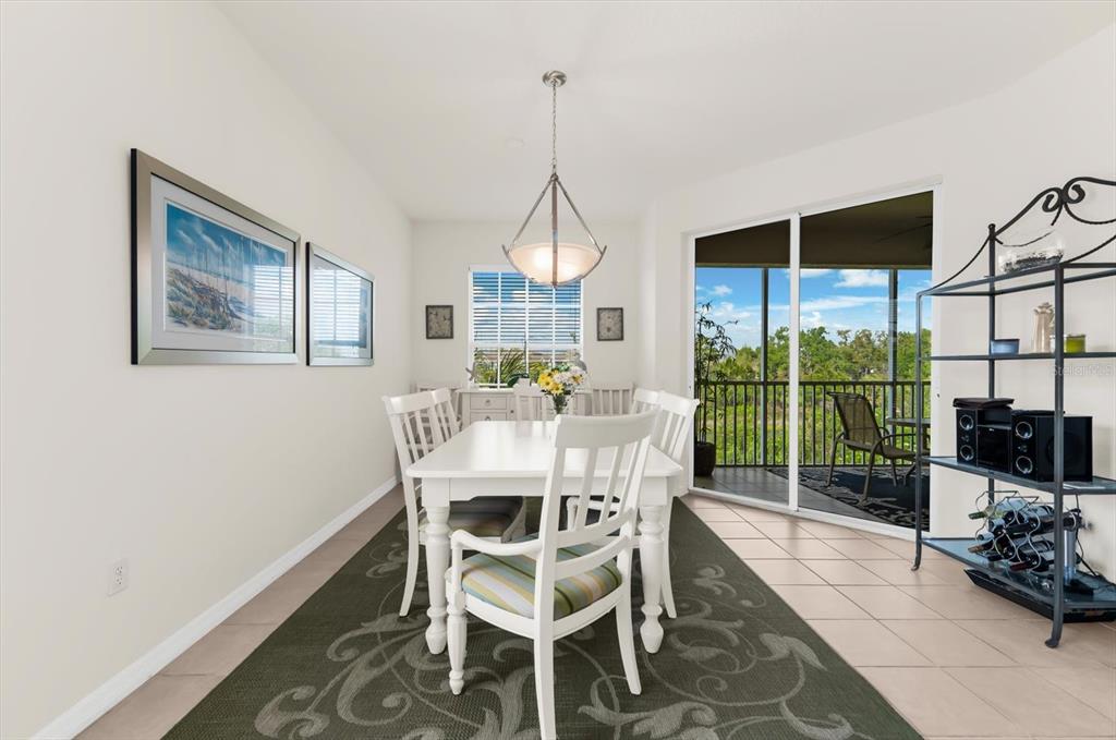 4500 Streamside Court, Unit 1408 Sarasota, FL 34238 - Photo 28 of 73 a dining room with furniture a chandelier and a window
