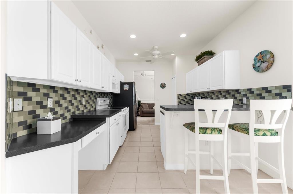 4500 Streamside Court, Unit 1408 Sarasota, FL 34238 - Photo 30 of 73 a kitchen with a sink and cabinets